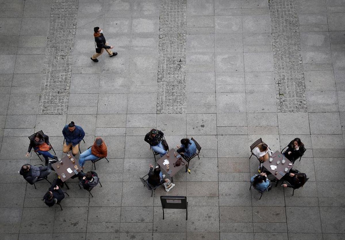 Tres grupos tomando algo en una terraza de la plaza del Castillo de Pamplona. 