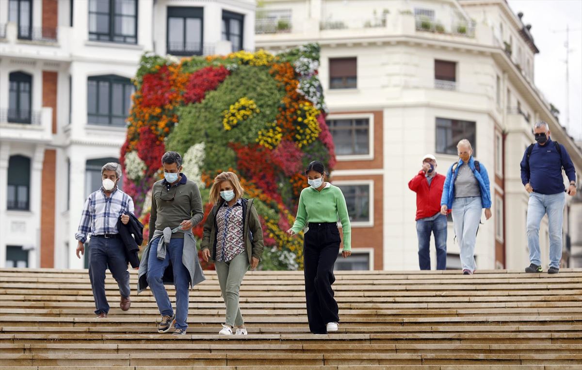 Varios turistas, con mascarilla, en Bilbao. 