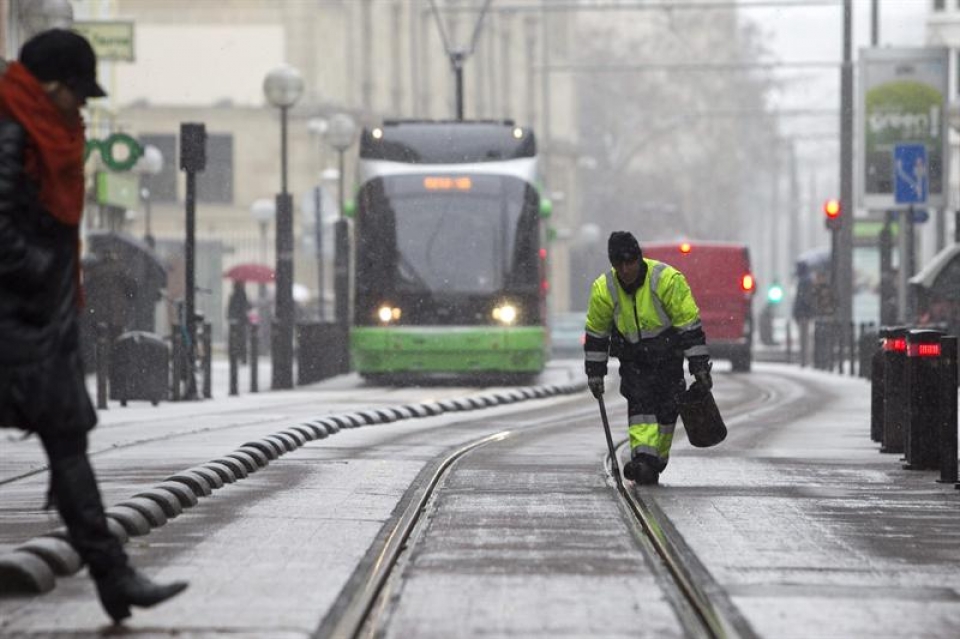 Un operario limpia las vías del tranvía en el centro de Vitoria. Foto: Efe