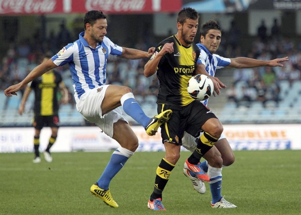 De La Bella y Edu Oriol luchan por el esférico. Foto: EFE