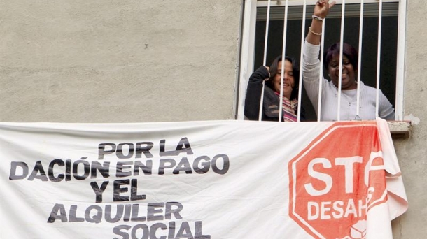 Dos mujeres protestan contra los desahucios.