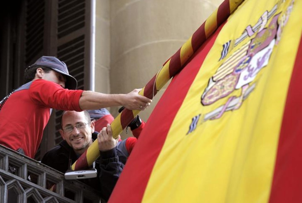 Dos personas se han encadenado a dos mastiles de la fachada. Foto: EFE