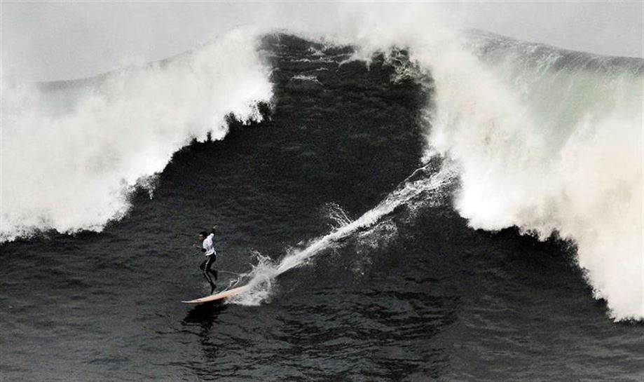 El surfista Kosme Fernández desciende una ola durante la XIII edición del Punta Galea Challenge, campeonato de surf de ola grande que se ha disputado hoy en Getxo