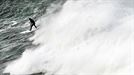 El surfista Pierre Rollet desciende una ola durante la XIII edición del Punta Galea Challenge, campeonato de surf de ola grande que se ha disputado hoy en Getxo title=