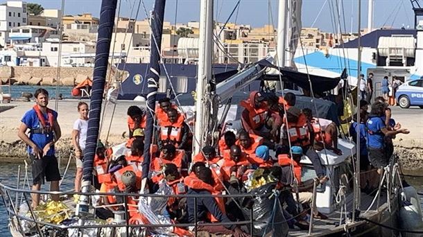 Varios migrantes a bordo del barco 'Alex' en un puerto italiano. 