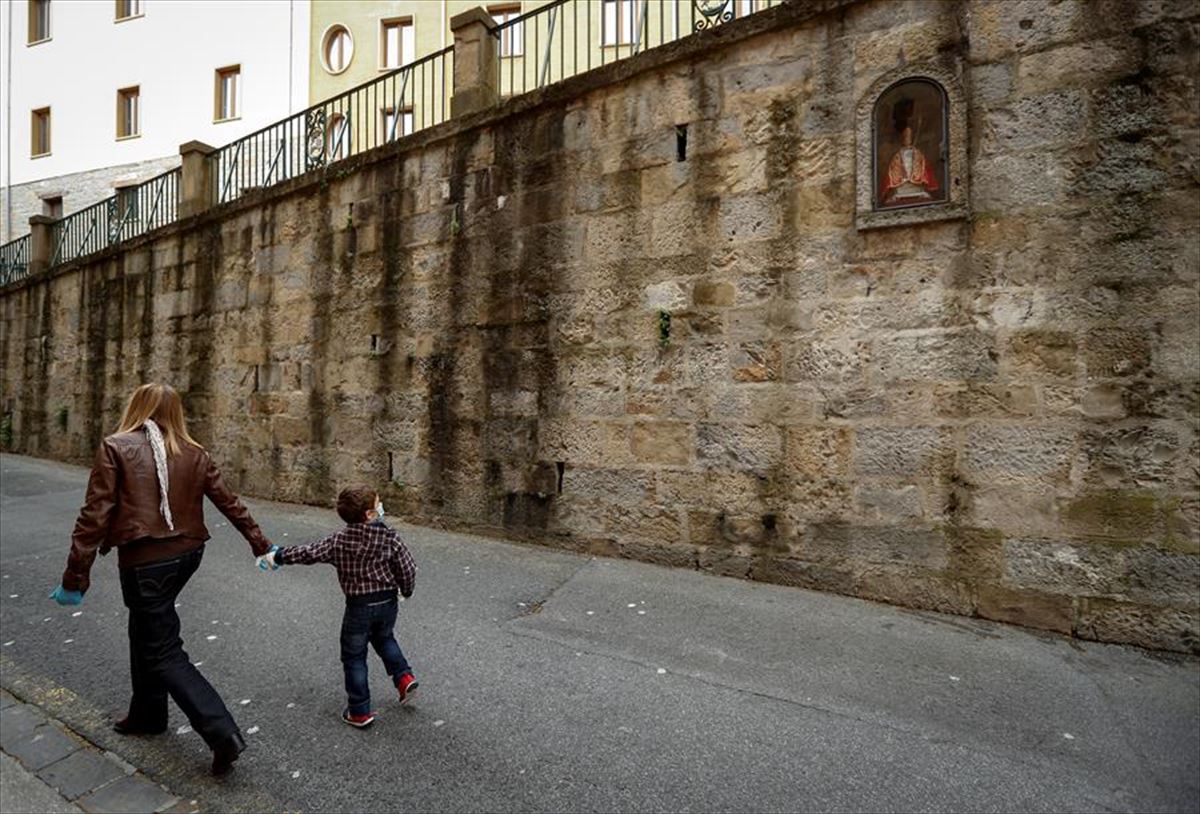 Un niño, con una persona adulta, en Pamplona. Foto: Efe