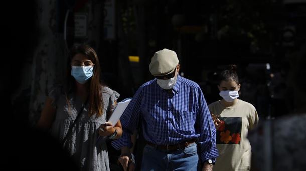 Personas paseando con mascarilla.