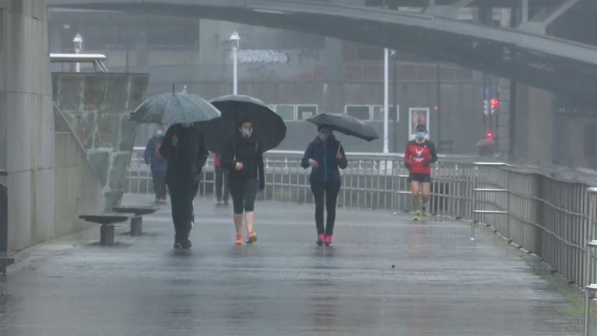 Varias personas caminan con sus paraguas por Bilbao