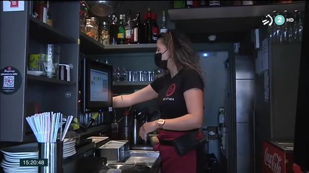 Una chica atiende la barra de un bar en Navarra. 