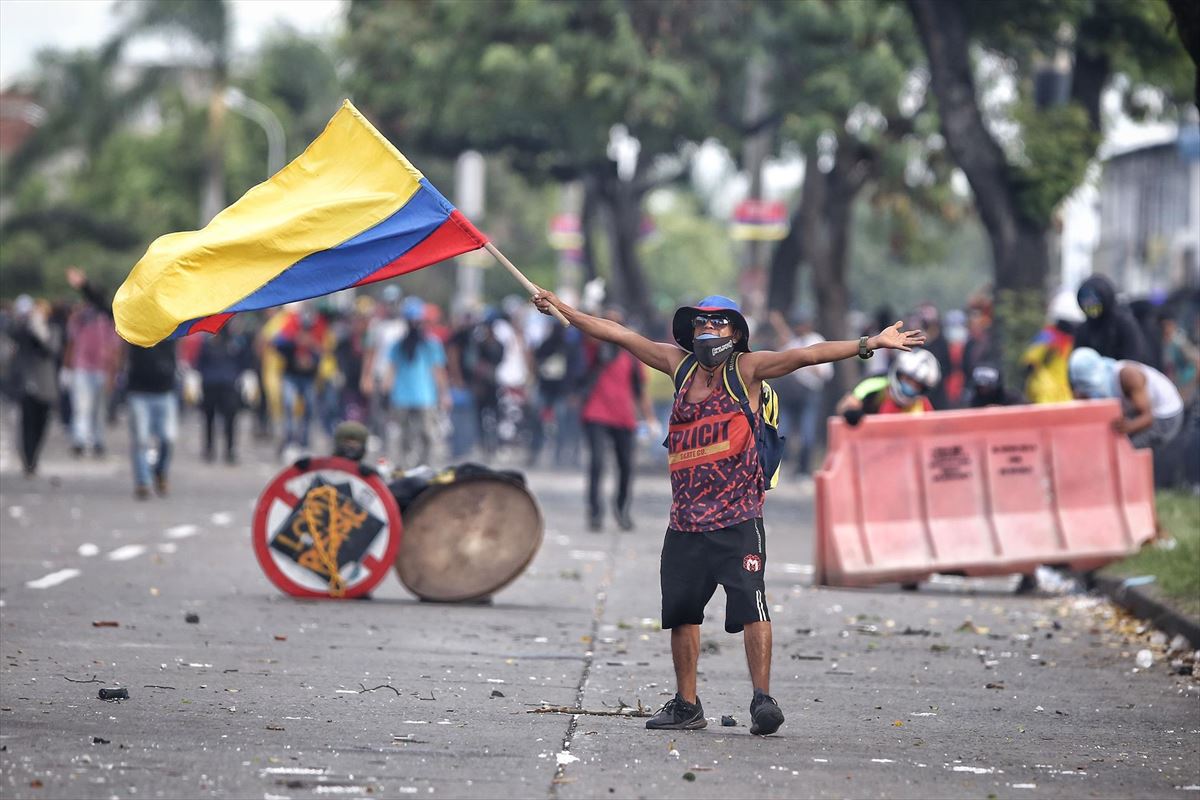 Un manifestante ondea hoy una bandera colombiana