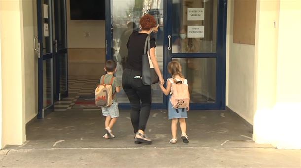Madre llevando a los niños al colegio