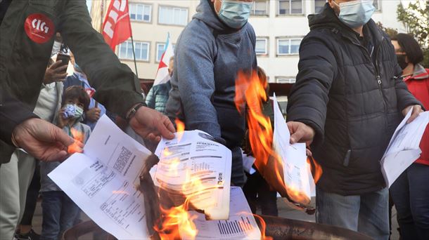 Pertsona talde batek argindarraren fakturak erre zituen igandean, Santiagon (Galizia). Argazkia: EFE