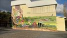 Un mural florido y diverso en el que quedan reflejados los concejos del municipio de Ribera Alta title=