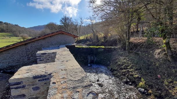 El concejo de Abezia rehabilita el muro de la presa y el puente de acceso al molino