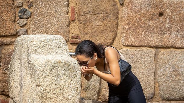 Una mujer se refresca en un día de calor sofocante. 