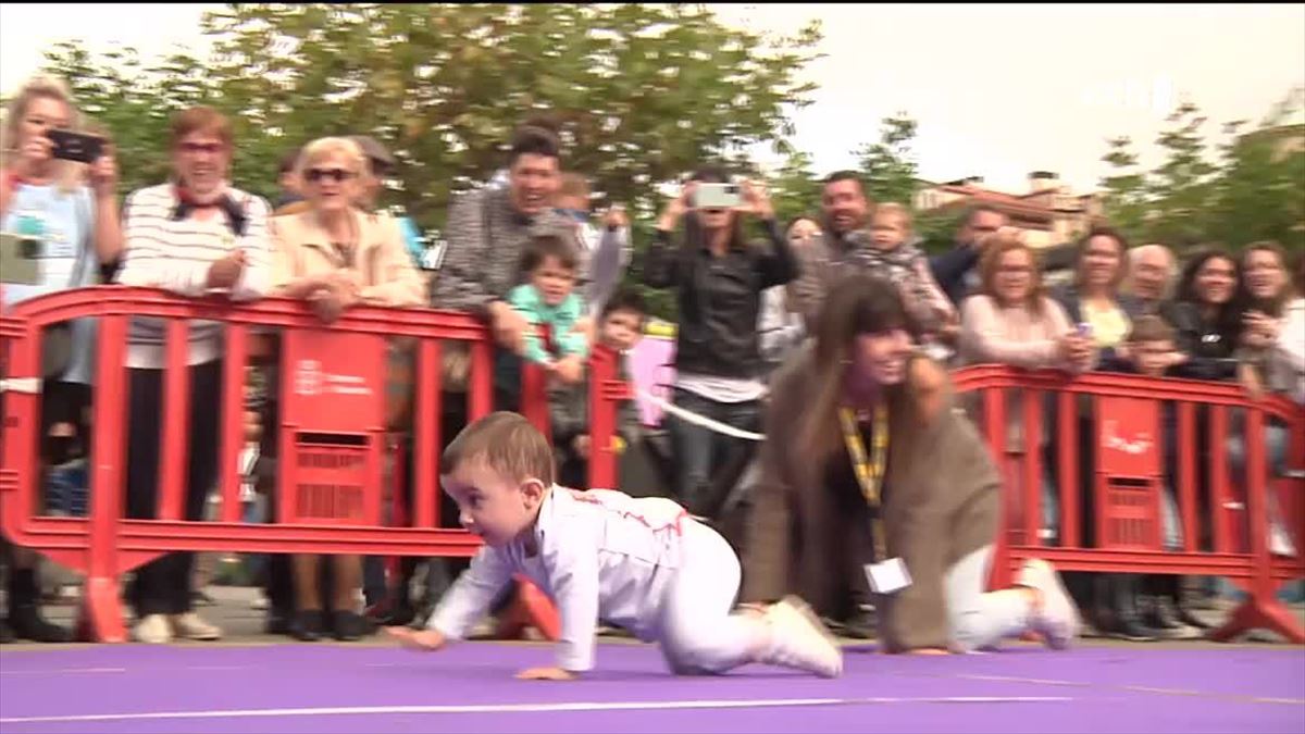 Un niño gatea en la carrera reivindicativa de Pamplona.