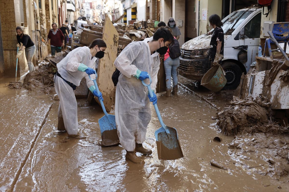 Voluntarios Achicando agua y limpiando los exteriores de Paiporta. Foto: EFE