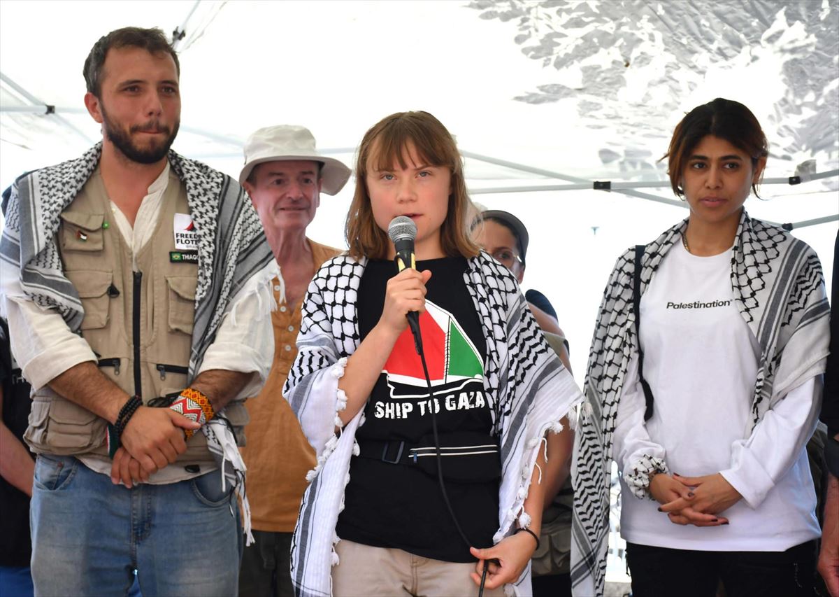 Greta Thunberg habla en medio de otros dos miembros de la Flotilla de la Libertad. Foto: EFE